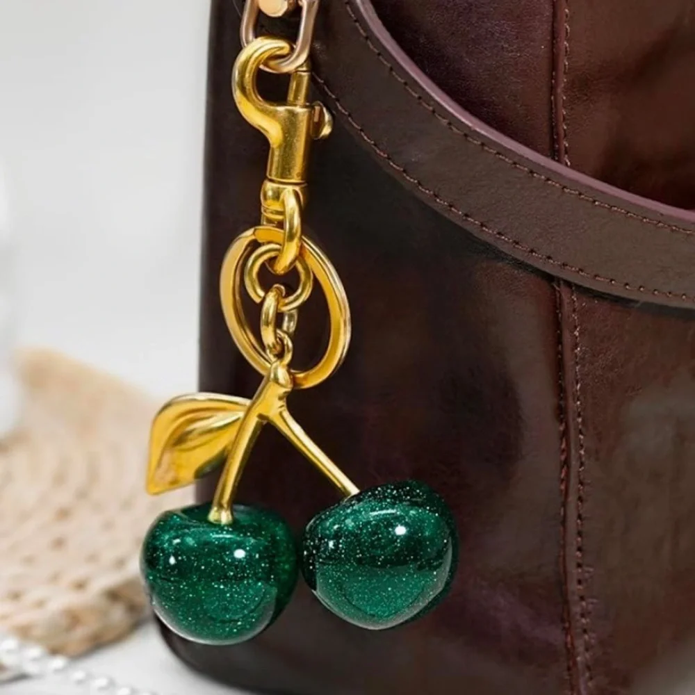 Cherry bag charm in hunter green with sparkles and gold hardware